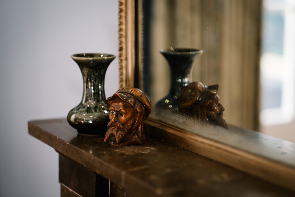 Antique man's head with beard and hat ornament