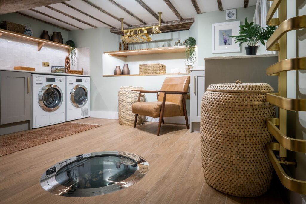 Bespoke cabinetry, well cover and lighting in a luxury laundry room designed by Charlotte Findlater Design, an award winning interior design studio specialising in luxury, high-end residential & commercial projects that respect time, nature and people.