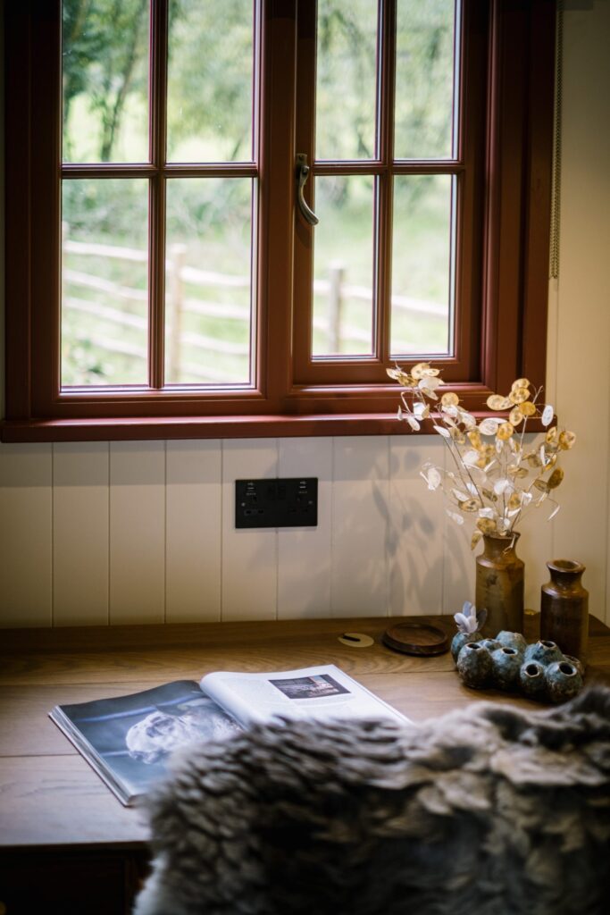 View of a desk in a Shepherds Hut looking out of a window