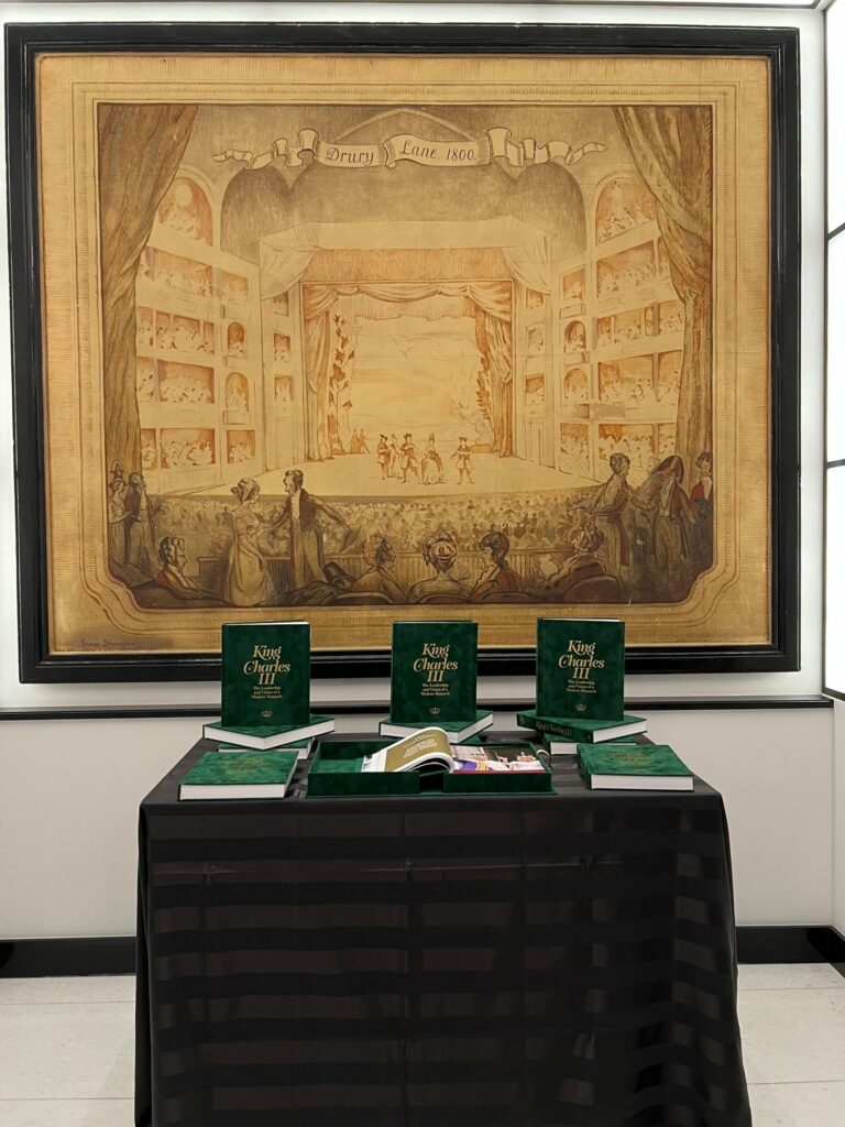 3 velvet covered books on a table at His Majesty King Charles III at 75: The Leadership and Vision of King Charles III, at Claridge’s in central London on His Majesty’s 75th birthday.