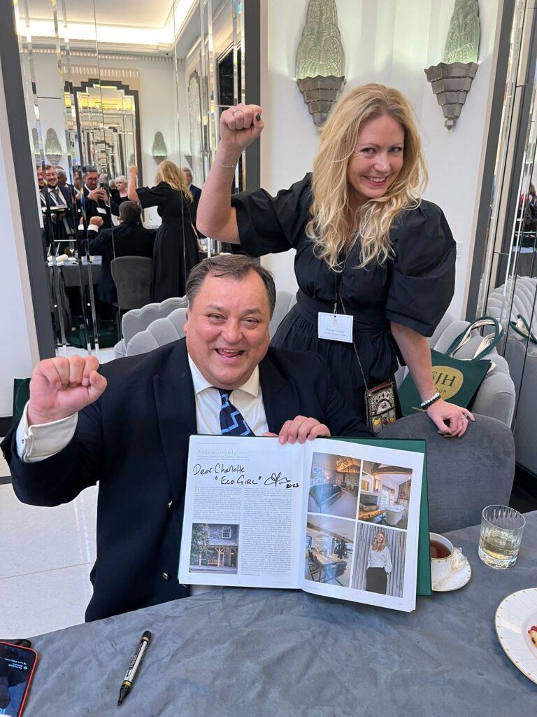 Charlotte Findlater and Robert Jobson with the signed 'eco girl' pages at His Majesty King Charles III at 75: The Leadership and Vision of King Charles III, at Claridge’s in central London on His Majesty’s 75th birthday.