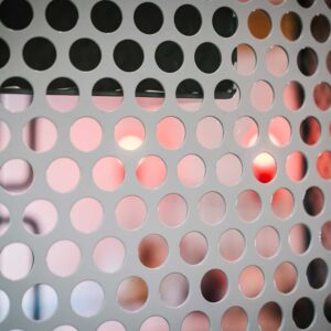Bespoke metal spiral staircase enclosed in a spherical perforated steel design