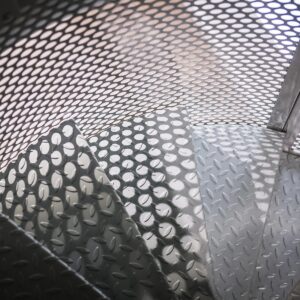 Bespoke metal spiral staircase enclosed in a spherical perforated steel design