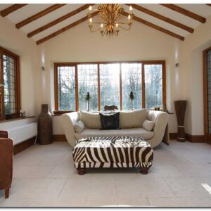 Garden room with beams, feature light, seating and leaded windows