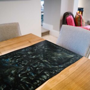 View of the end of a bespoke dining table made from combining resin and wild walnut to create a river resin design