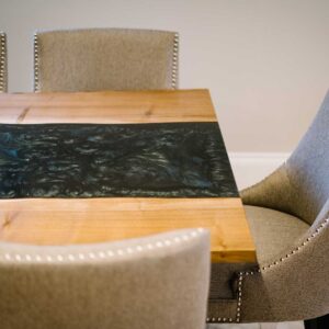 View of the end of a bespoke dining table made from combining resin and wild walnut to create a river resin design