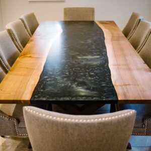 Bespoke dining table made from combining resin and wild walnut to create a river resin design with seating for 8
