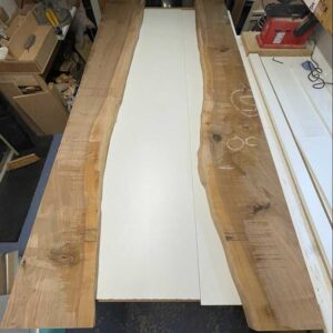 Raw wild walnut slabs before combining resin and wild walnut to create a bespoke river resin dining table.