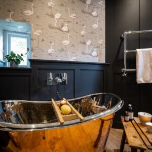 Bathroom with stunning copper bath and towel radiator