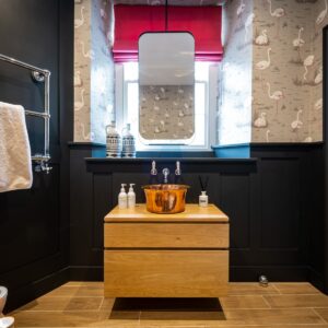 Bathroom with stunning copper basin and suspended vanity mirror
