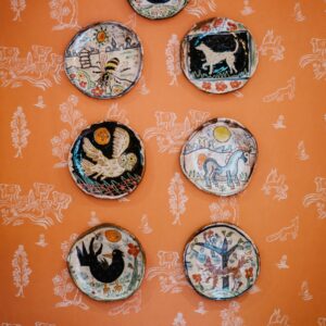 6 Wabi Sabi hand crafted animal theme plates mounted on a bedroom wall