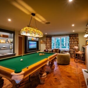 Luxury games room with bespoke Oak pool table, parquet flooring, stone fireplace, built ins and media wall