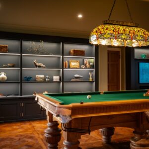 Luxury games room with bespoke Oak pool table and bespoke built in cabinetry