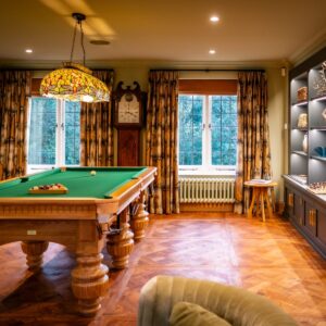 Luxury games room with bespoke Oak pool table, bespoke built in cabinetry and parquet flooring