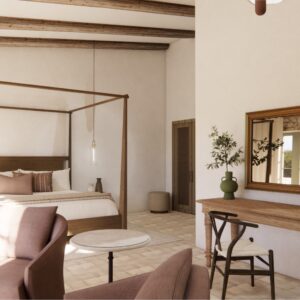 A render of a traditional Menorcan farmhouse stable styled outbuilding bedroom with seating for 2 and a large four poster bed